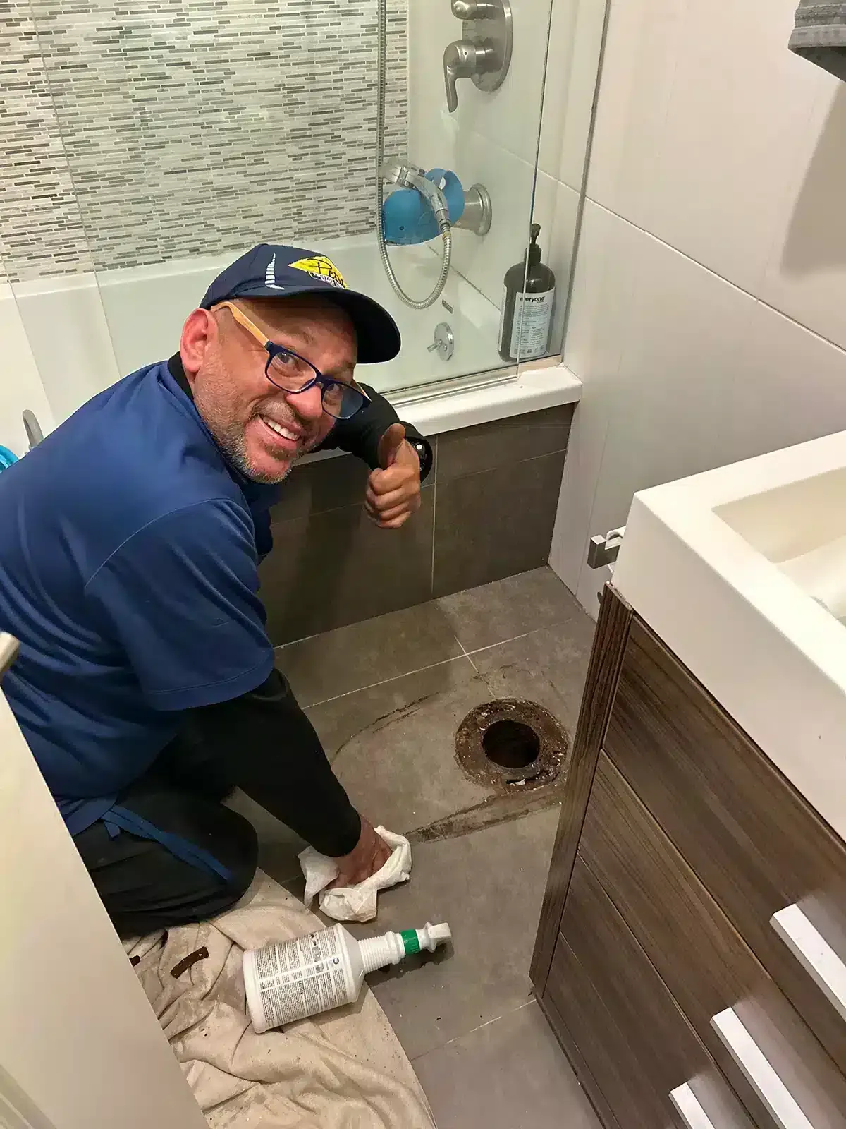 Petri Technician smiling and giving a thumbs up during a bathroom fixture installation job in Brooklyn, NY.